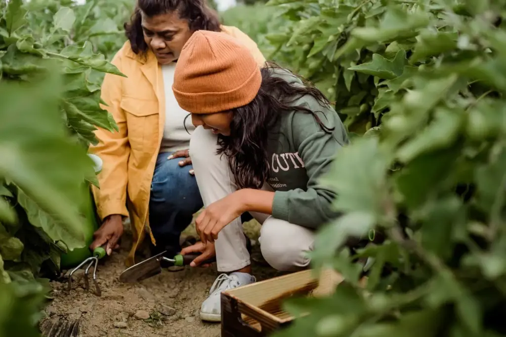 girl and woman digging the soil